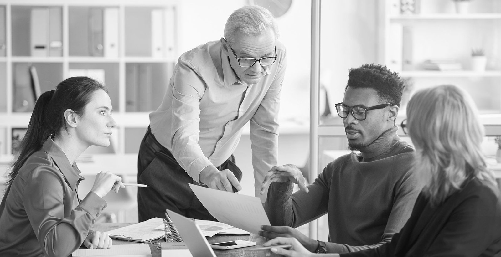 An attorney reviewing documents with a client at a desk