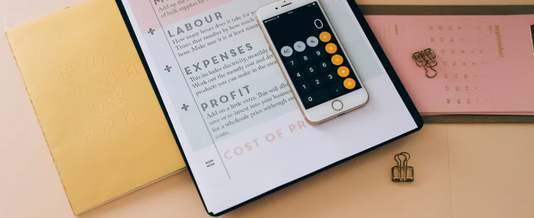 Calculator on a cost planner with labour, expenses and profit sections, representing law firm website cost