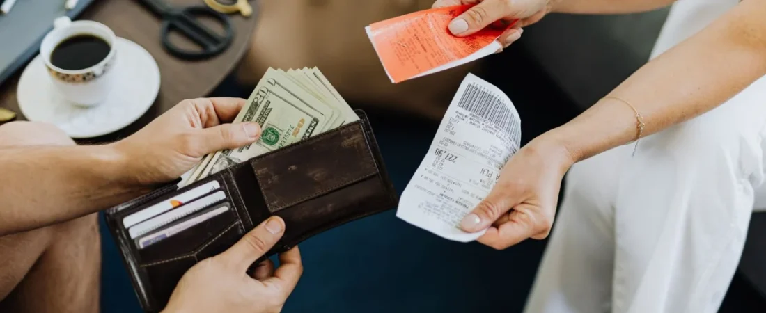 Calculator and bills on a desk, the financial pressure a bankruptcy client arrives with