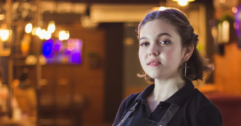 Restaurant server carrying a tray of food