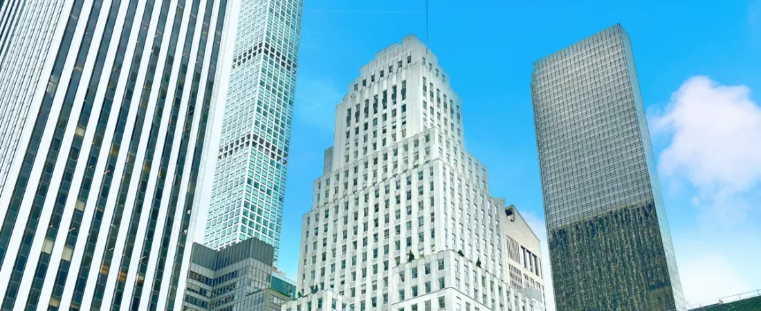 Manhattan office towers against a blue sky