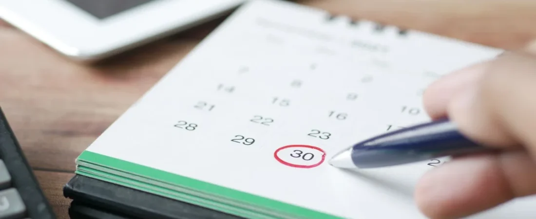 Hand circling a deadline on a calendar