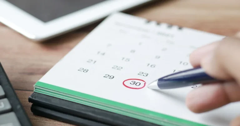 Hand circling a deadline on a calendar