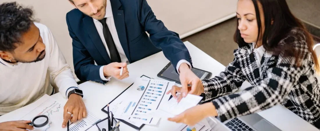 Legal team reviewing marketing strategy charts at a conference table
