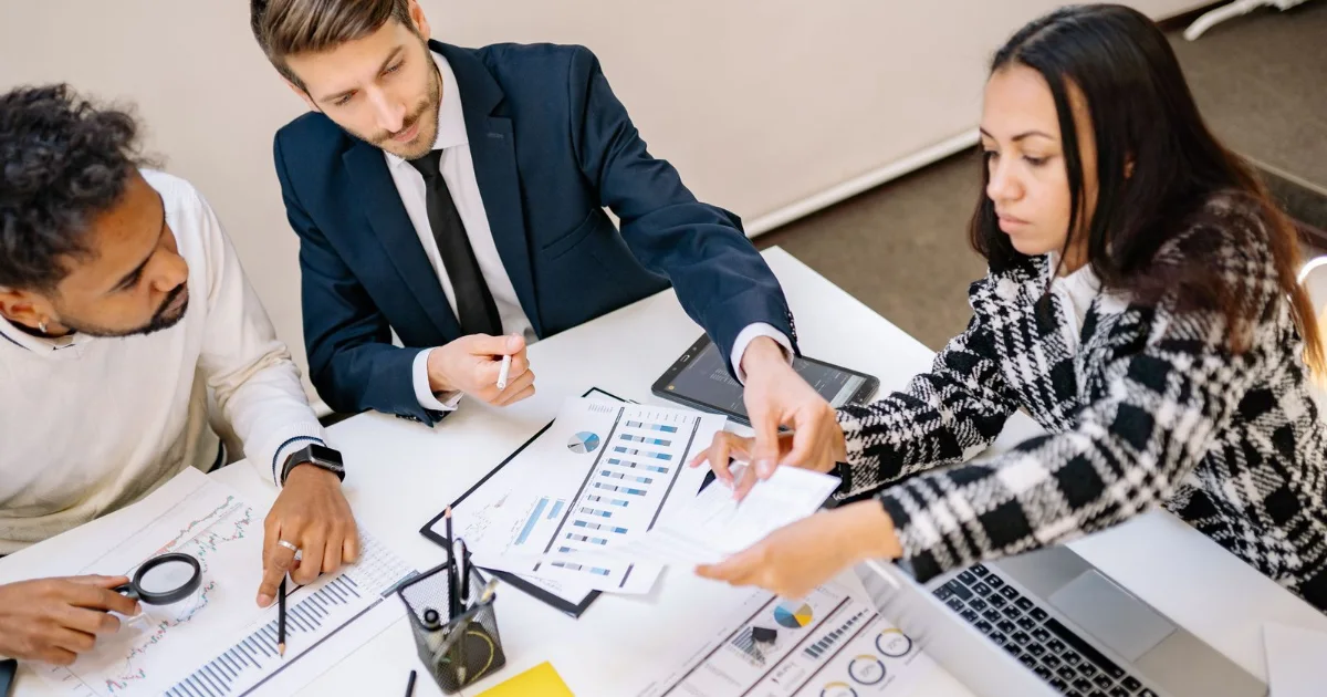 Legal team reviewing marketing strategy charts at a conference table
