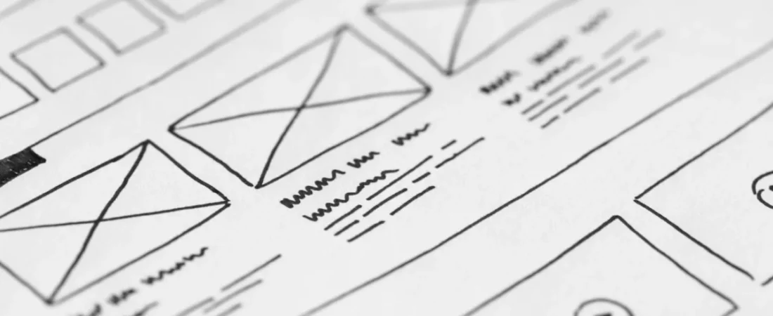 Hand-drawn website wireframe sketch on paper