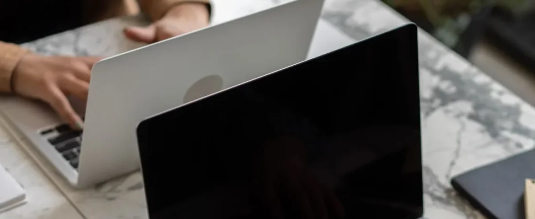 Writer drafting law firm website content at a desk with a laptop and notes