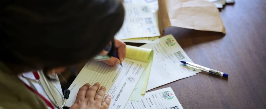 Doctor filling out medical records