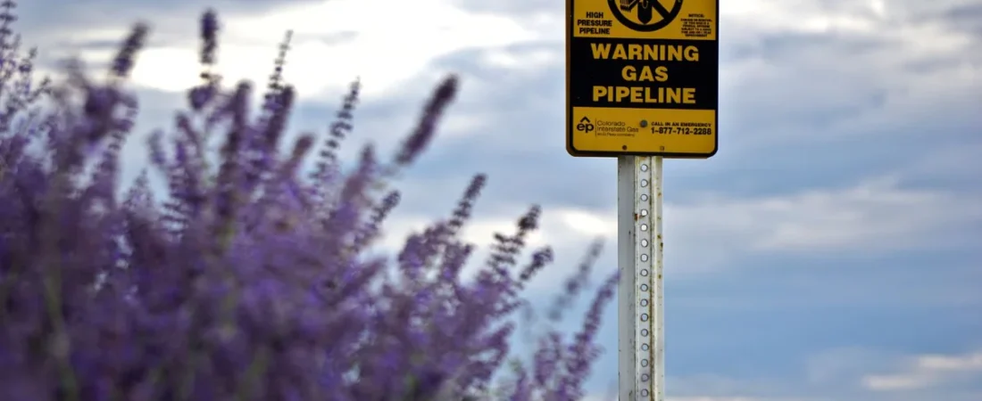 Gas pipeline warning sign on rural land
