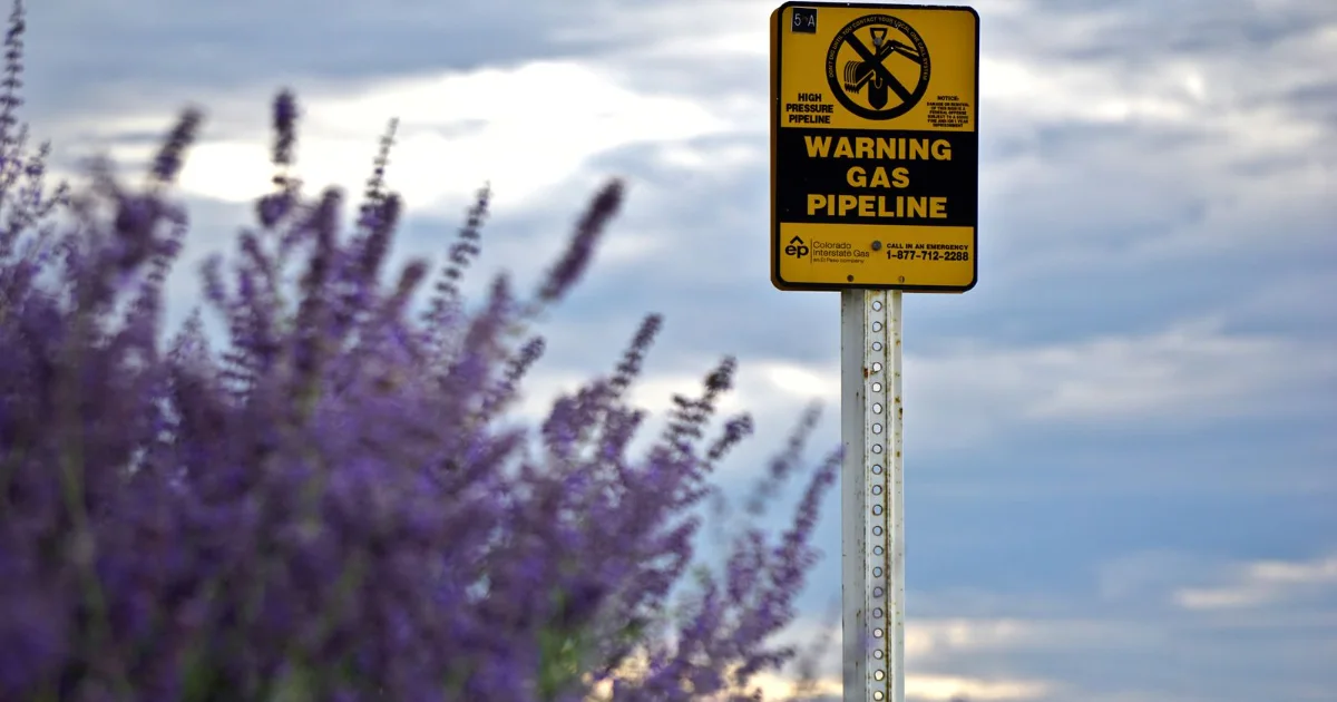 Gas pipeline warning sign on rural land