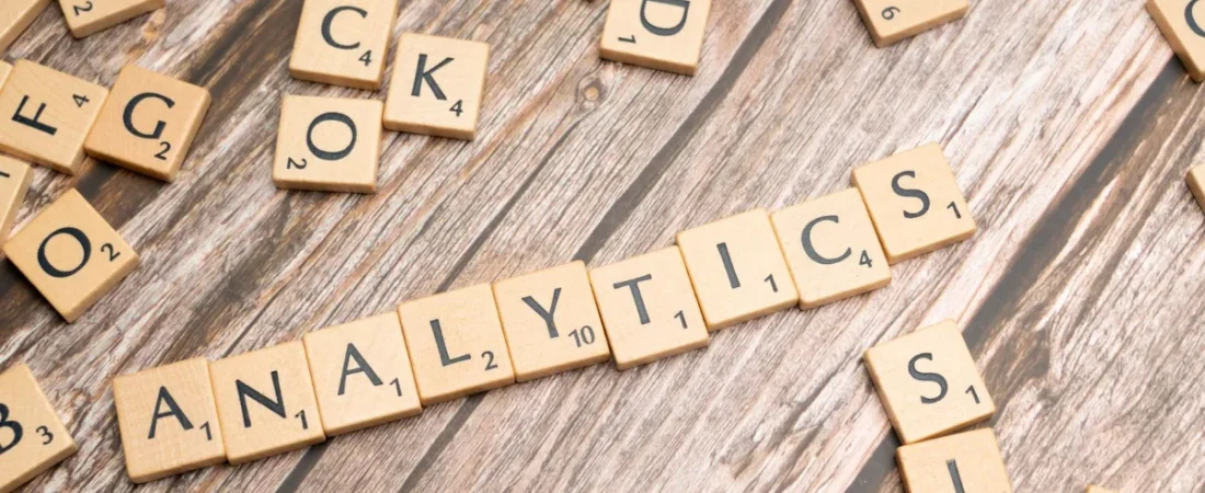 Letter tiles spelling analytics on a wooden table